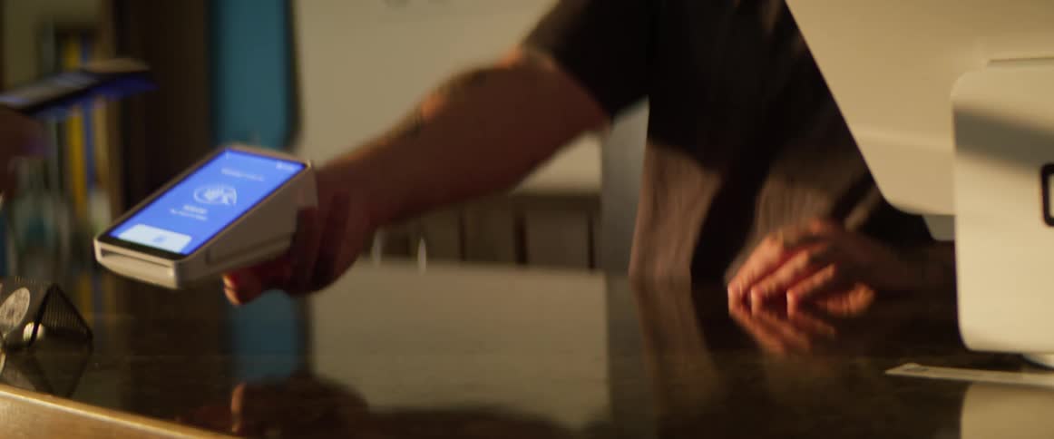 A footage of a person making payment with a pos