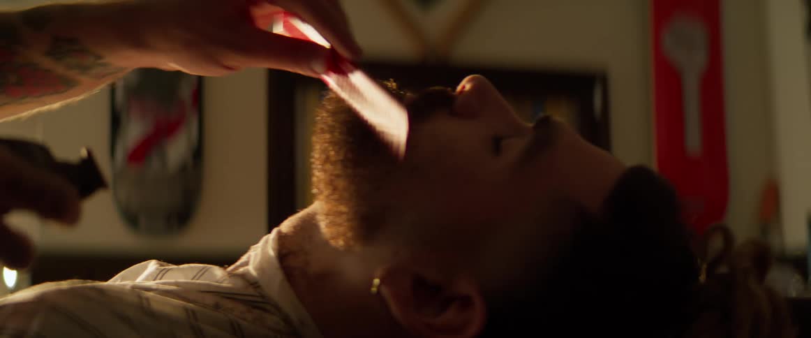 Boy whose beard is cut off with a razor