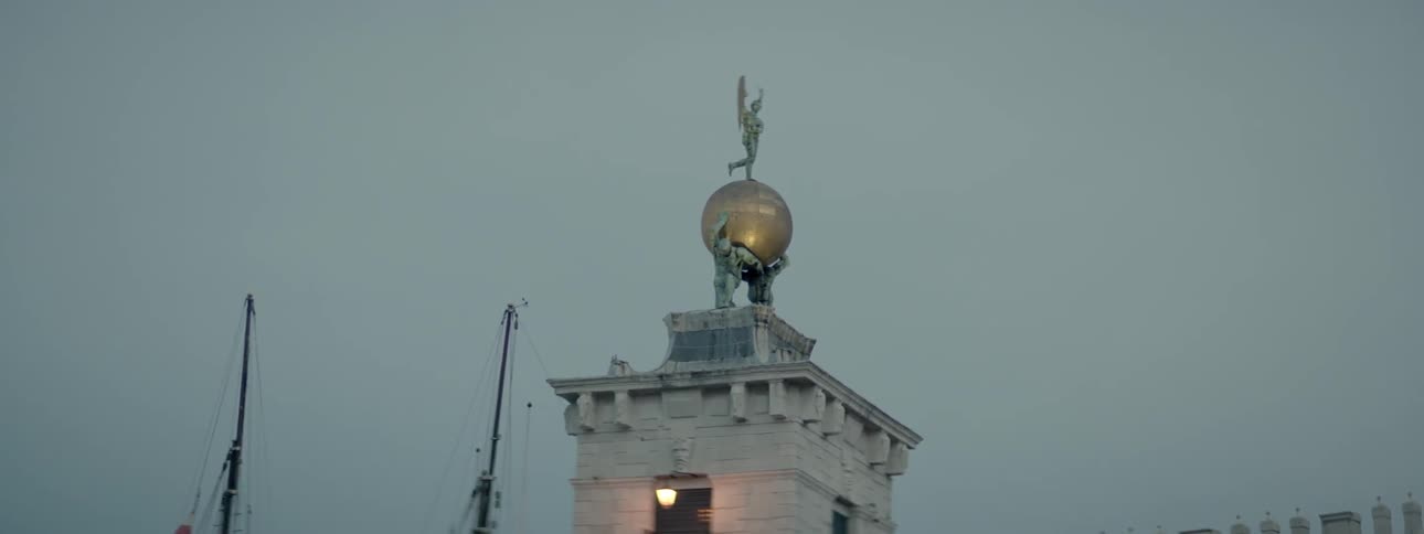A statue stands tall on a building