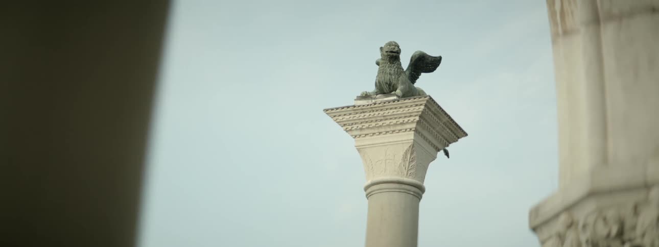 A view of the upper part of a  statue standing in the city