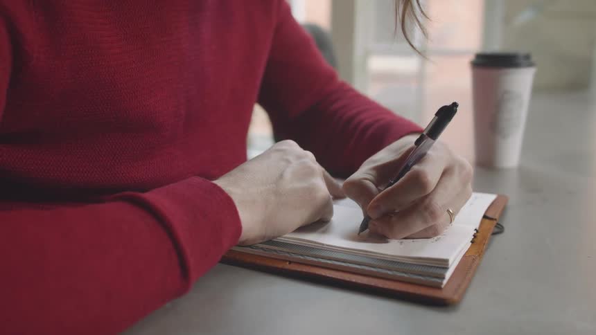 Woman writing in a notebook