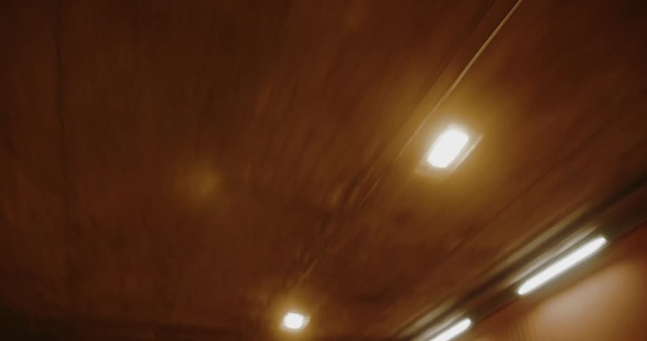 Lights line the ceiling and walls of the inside of a building