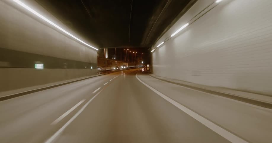 Road of a tunnel all lit up and then seen in the night sky
