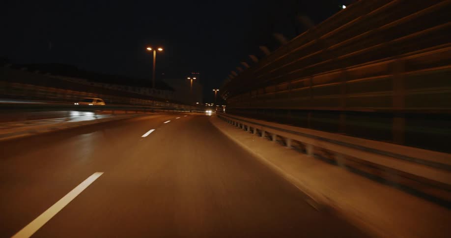 Cars drive on the highway at night