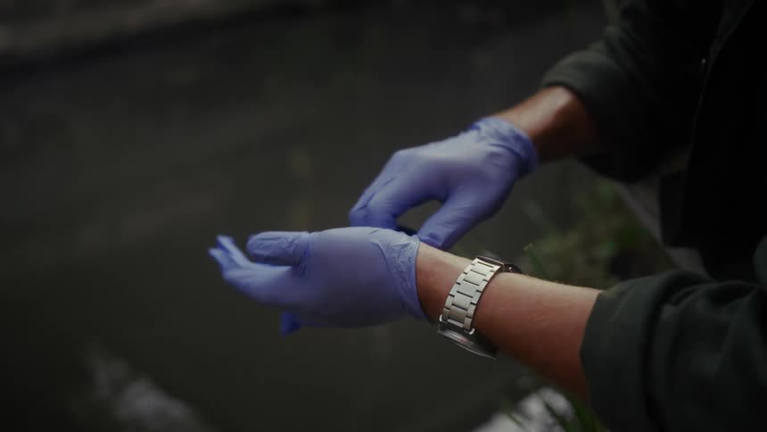 Man putting on gloves