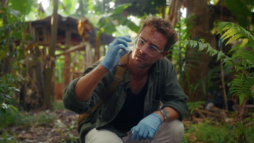 A scientist is testing water in the forest
