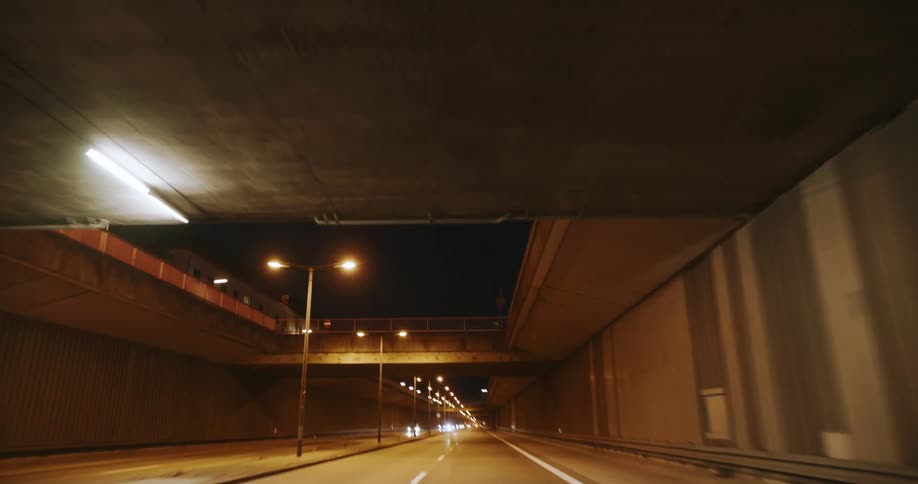 The long dark tunnel has an opening at the top showing the night sky