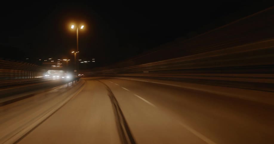 Cars speed through the tunnel at night