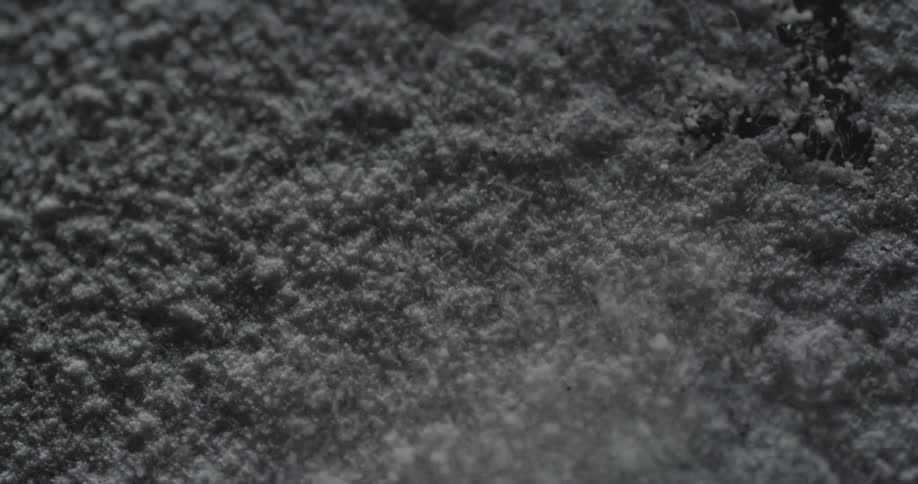 Particles of something vibrating and bouncing into the air from the vibration below them