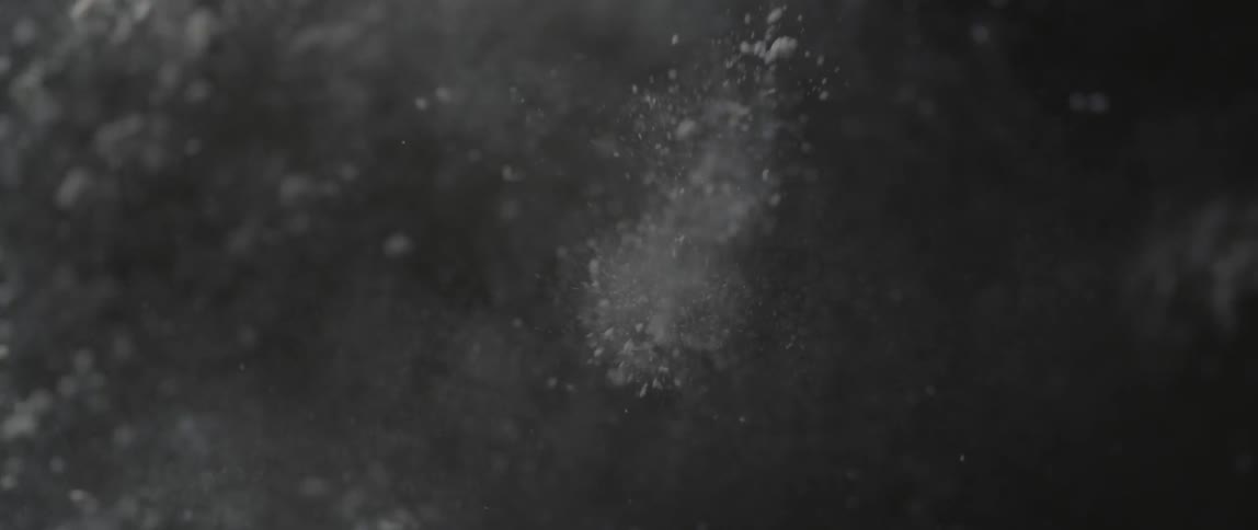 Dirt and dust fly into the air from a small explosion
