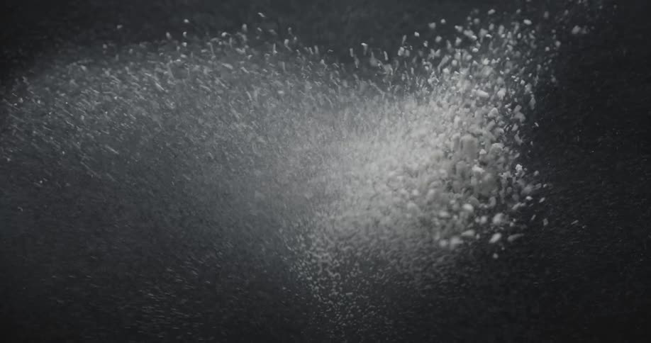 Some particles on the ground that are vibrating and rising