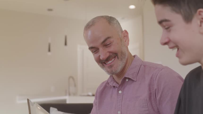 Father and son laugh and talk