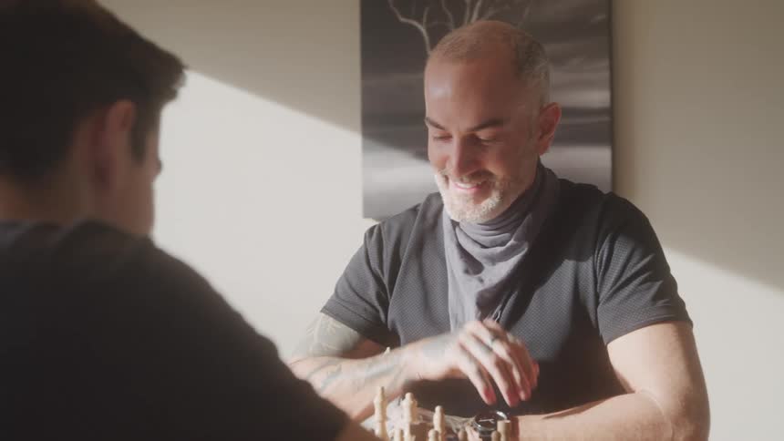 Father and son play a game of chess together