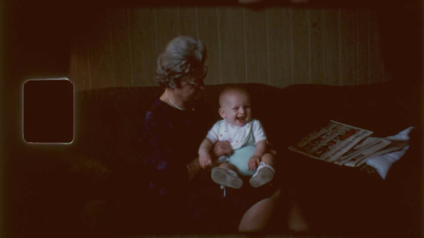 A grandmother holds her grandson in her arms