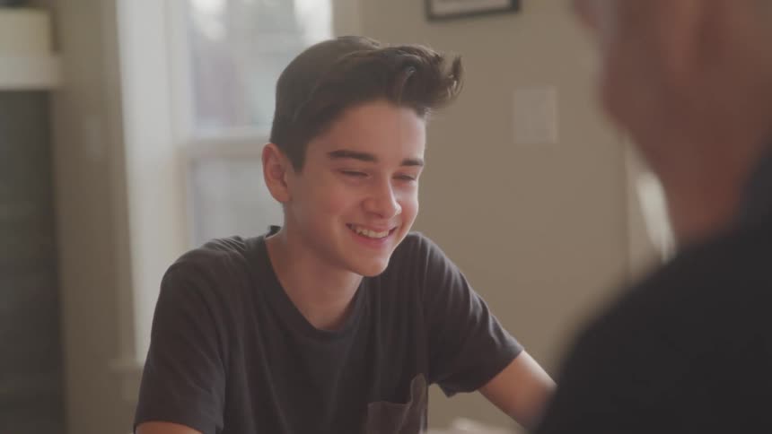 Father and son play a card game together