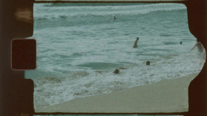 Teenagers are playing in the water and jumping in the waves