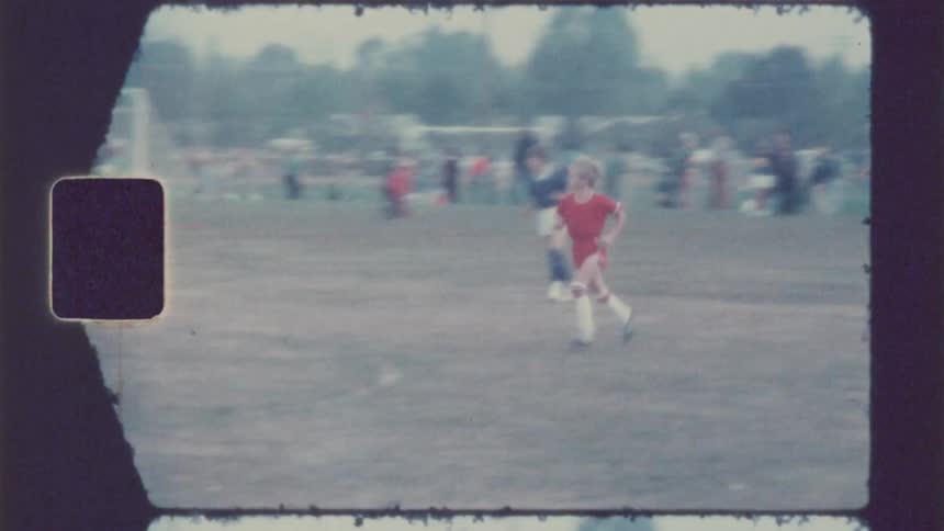 A blurry youth soccer game on a cloudy day