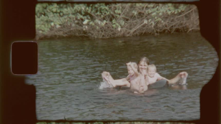 Mom with children on top of a float in a lake