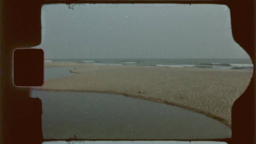 People are swimming in the water by the beach