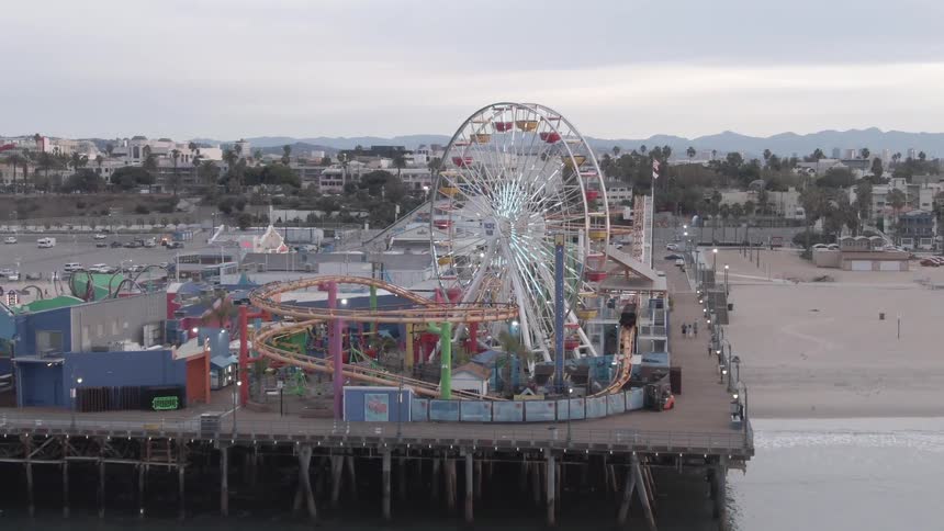 A carnival is on the boardwalk on the beach