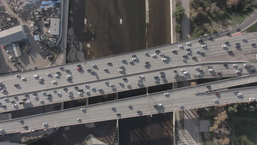 Trucks and cars move on the roads on the overpass