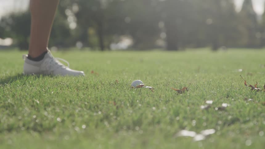 Golfer swings their club and hits the golf ball