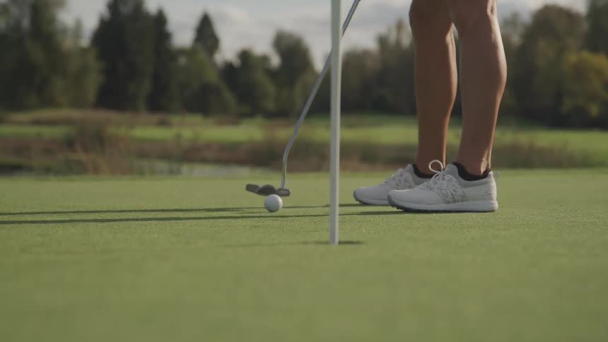 A woman scores while playing golf