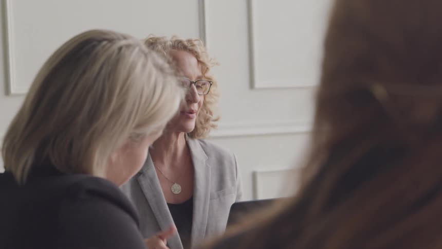 Coworkers are smiling and talking during a meeting