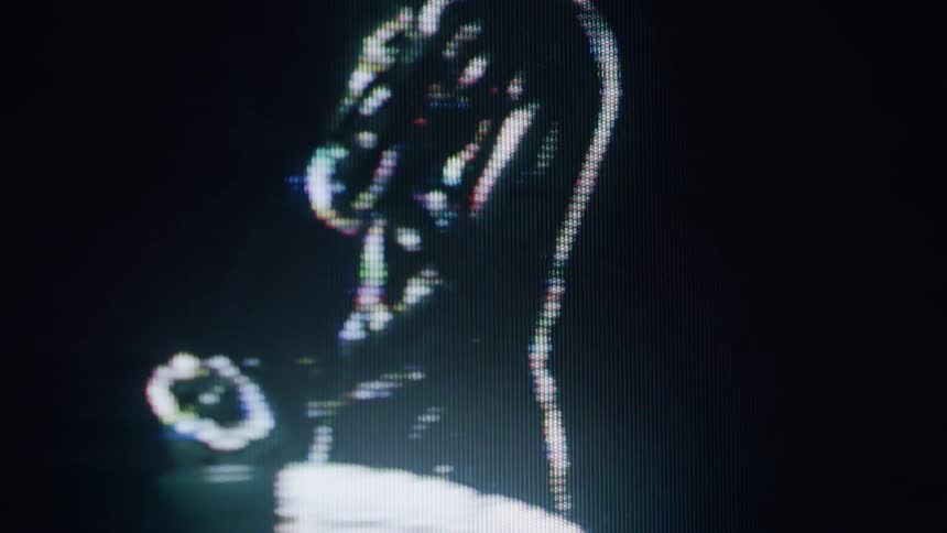 A dancing woman is on the screen as a hologram