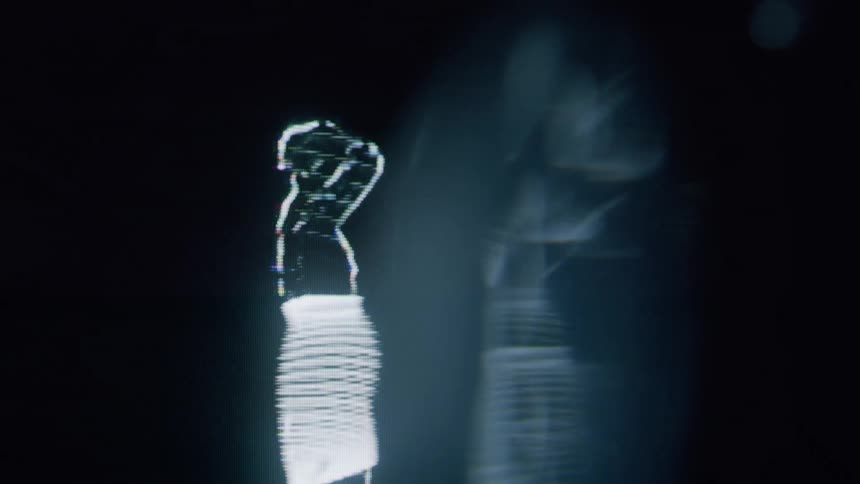 Woman in silhouette comprised of white bands of light dances