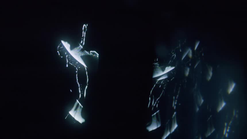 Female silhouettes comprised of white bands dance in the dark