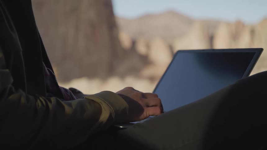 A footage of a person typing on a laptop