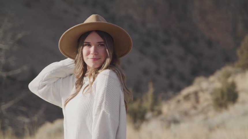 A woman is smiling by the mountain