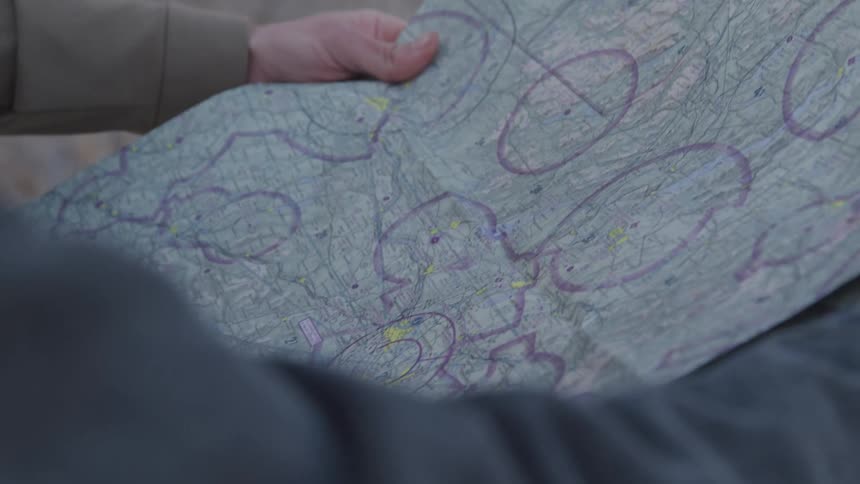 A person is pointing to spots on the map