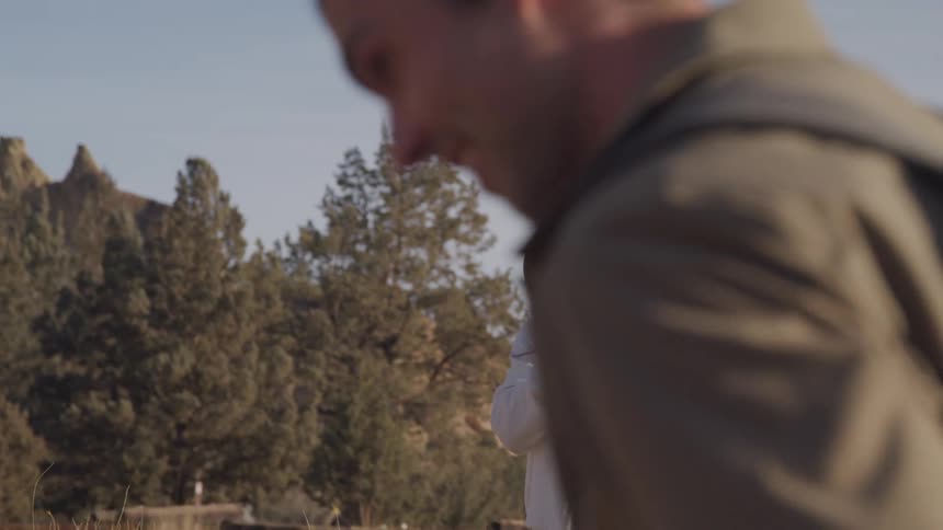A woman is recording a man on the farm