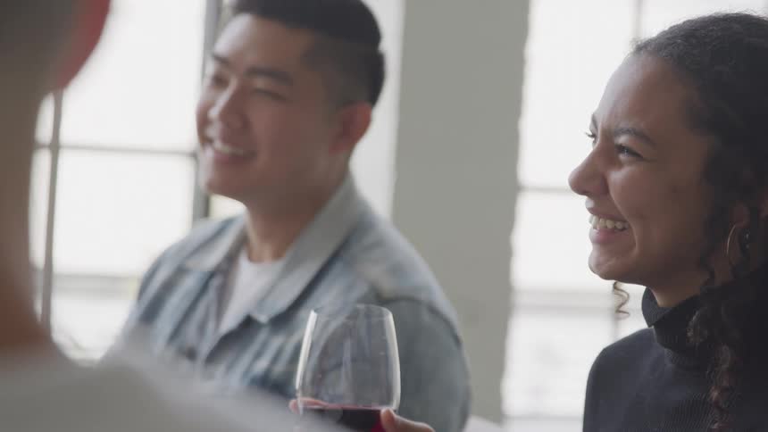 People holding glasses of wine and smiling