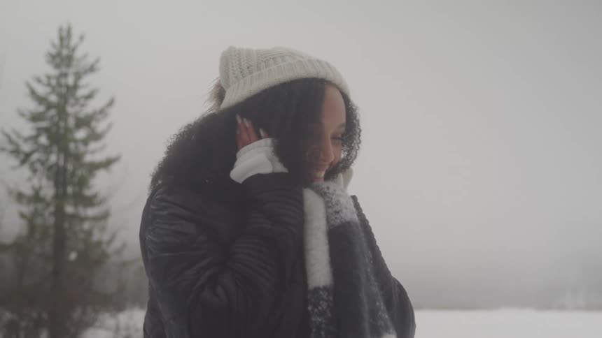 Woman is happily surprised outdoors in the winter