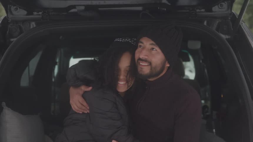 Couple sitting in the car hugging each other