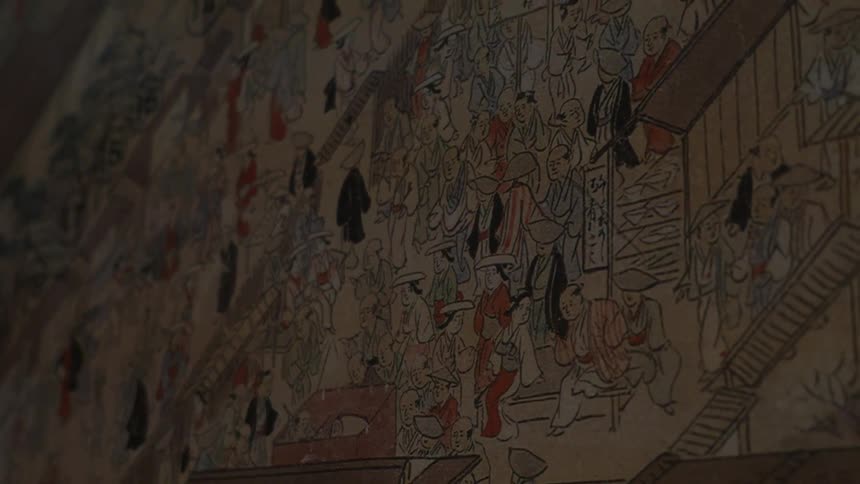 The wall is covered with drawings in this dark area