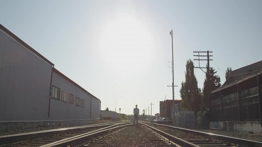 Boy stopped in the middle of train tracks