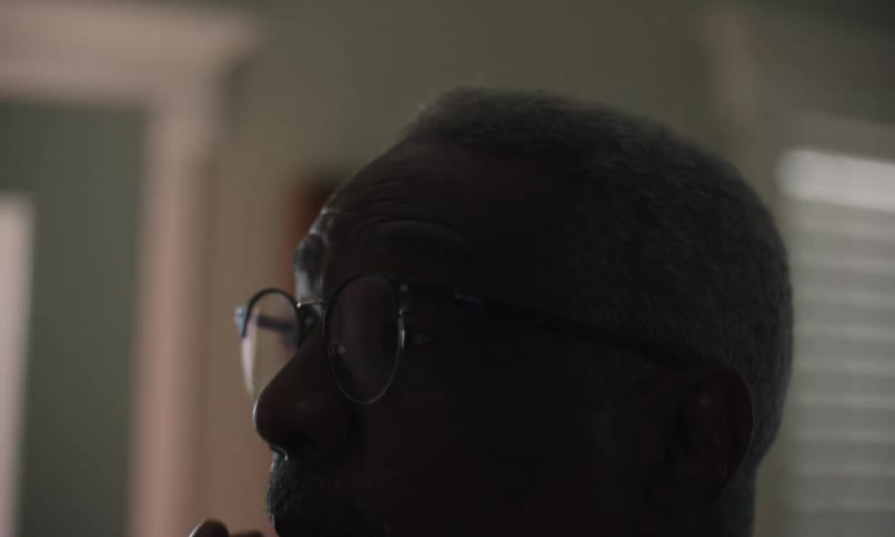 A man is brushing his beard and hair