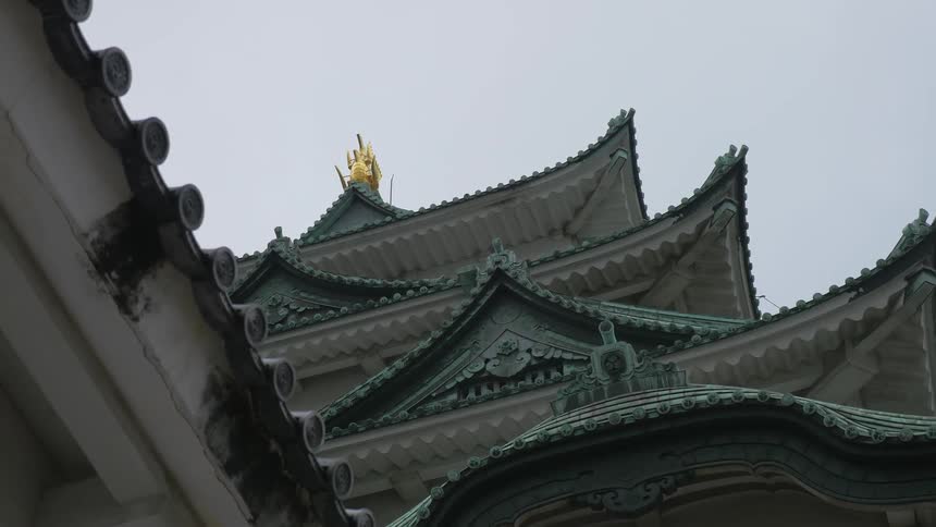 A view of the top of some buildings as the camera person is looking up