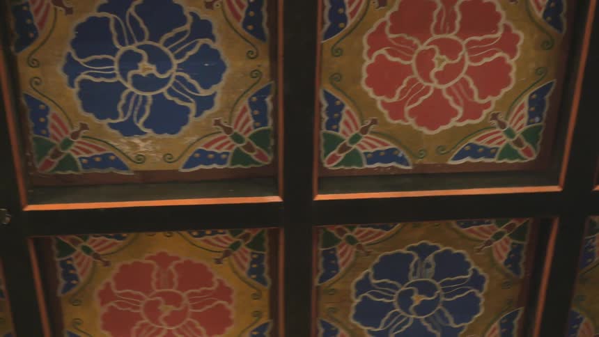 Decorative tiles cover a ceiling