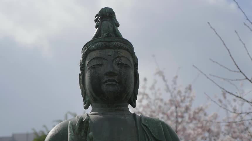 A statue sits under a cloudy sky
