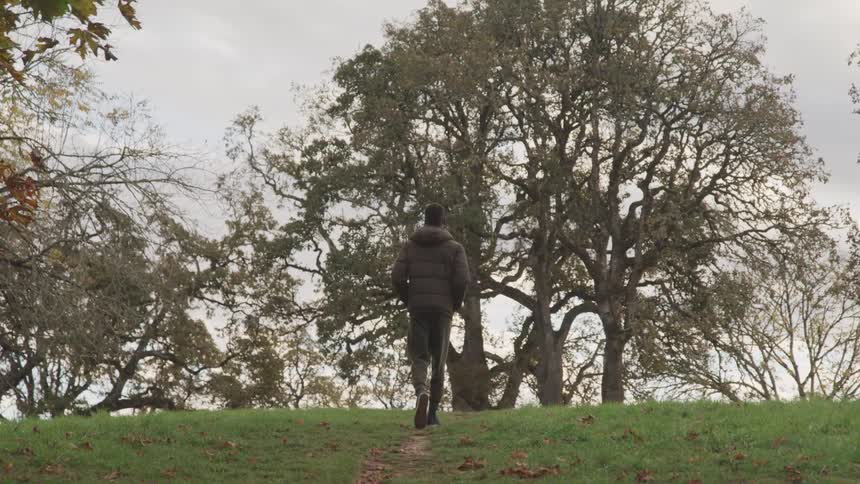 Boy with his back turned walking in nature