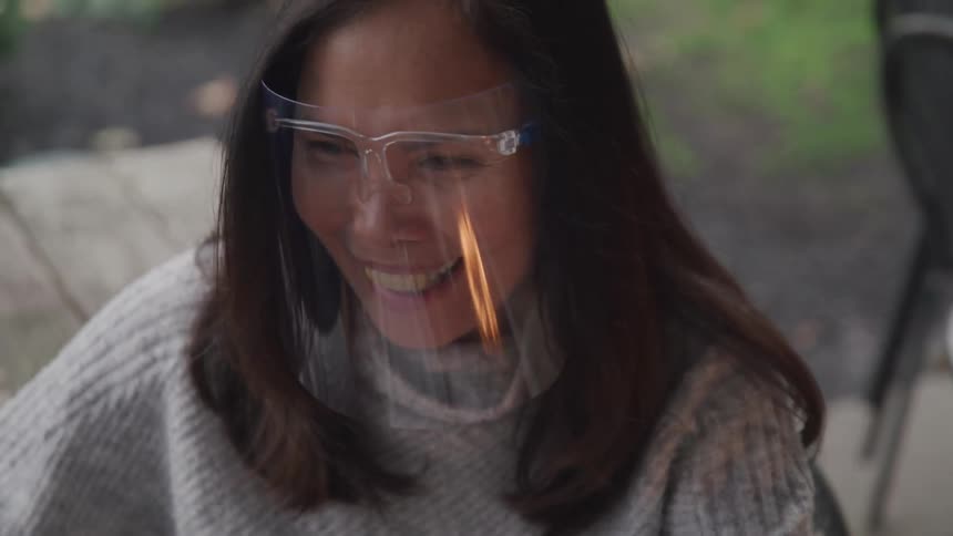 Woman with protectors on her face talking to someone