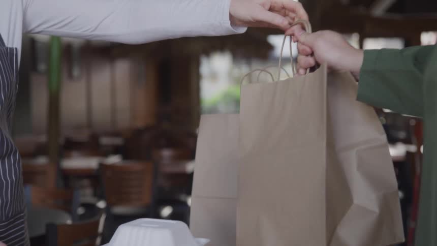 Customer picking up to go order from a restaurant