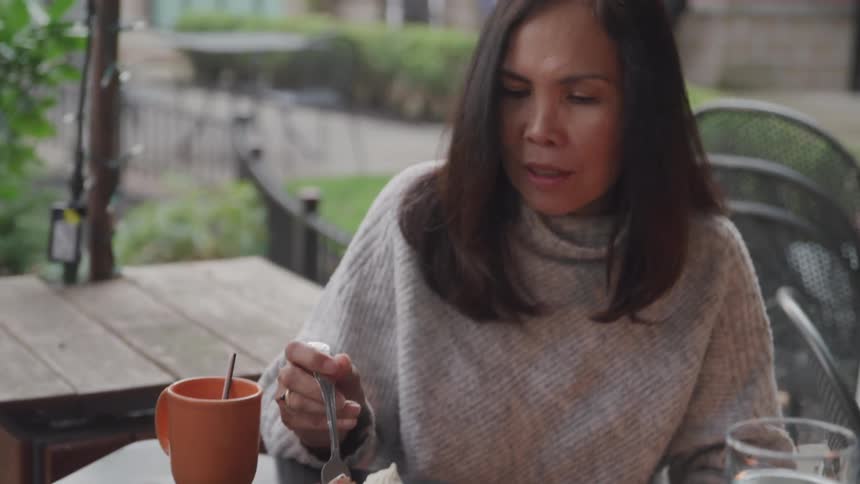 A woman tries to feed her husband cake
