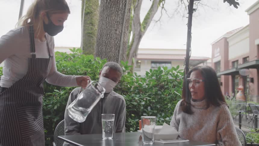 A clip of a person serving water on table