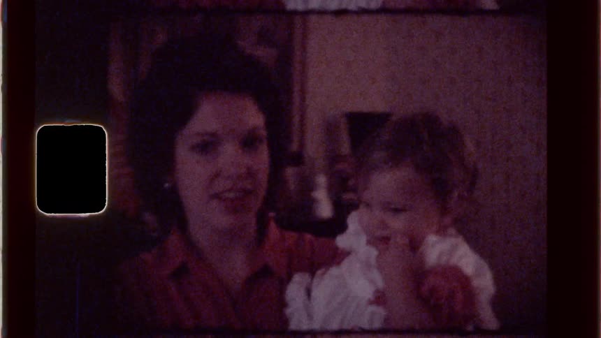 Mother holds her baby daughter and talks to her